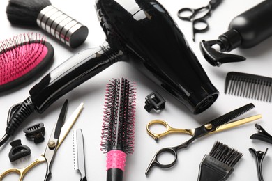 Photo of Different hairdresser's tools on light grey background