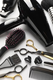 Photo of Different hairdresser's tools on light grey background, above view