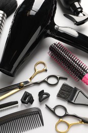 Photo of Different hairdresser's tools on light grey background, above view