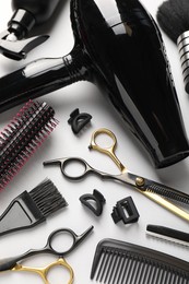 Photo of Different hairdresser's tools on light grey background, above view
