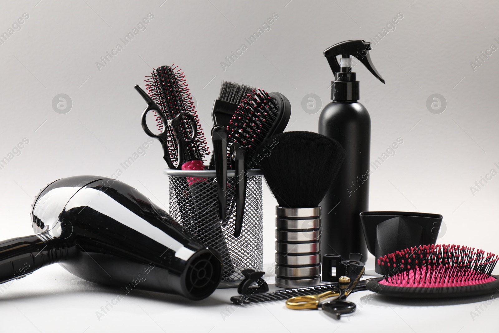 Different hairdresser's tools on light grey background, closeup Photo of Different hairdresser's tools on light grey background, closeup
