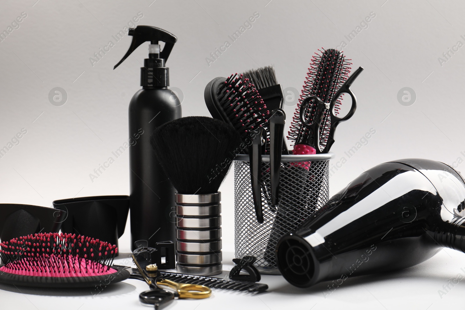 Different hairdresser's tools on light grey background, closeup Photo of Different hairdresser's tools on light grey background, closeup