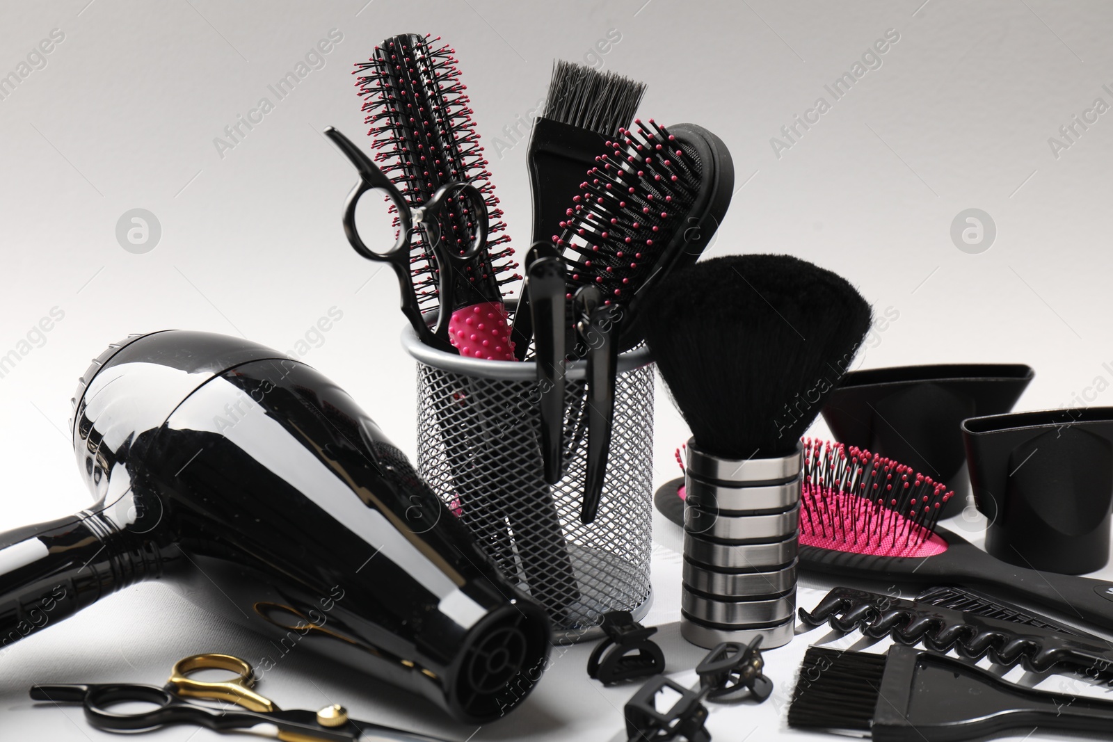 Different hairdresser's tools on light grey background, closeup Photo of Different hairdresser's tools on light grey background, closeup