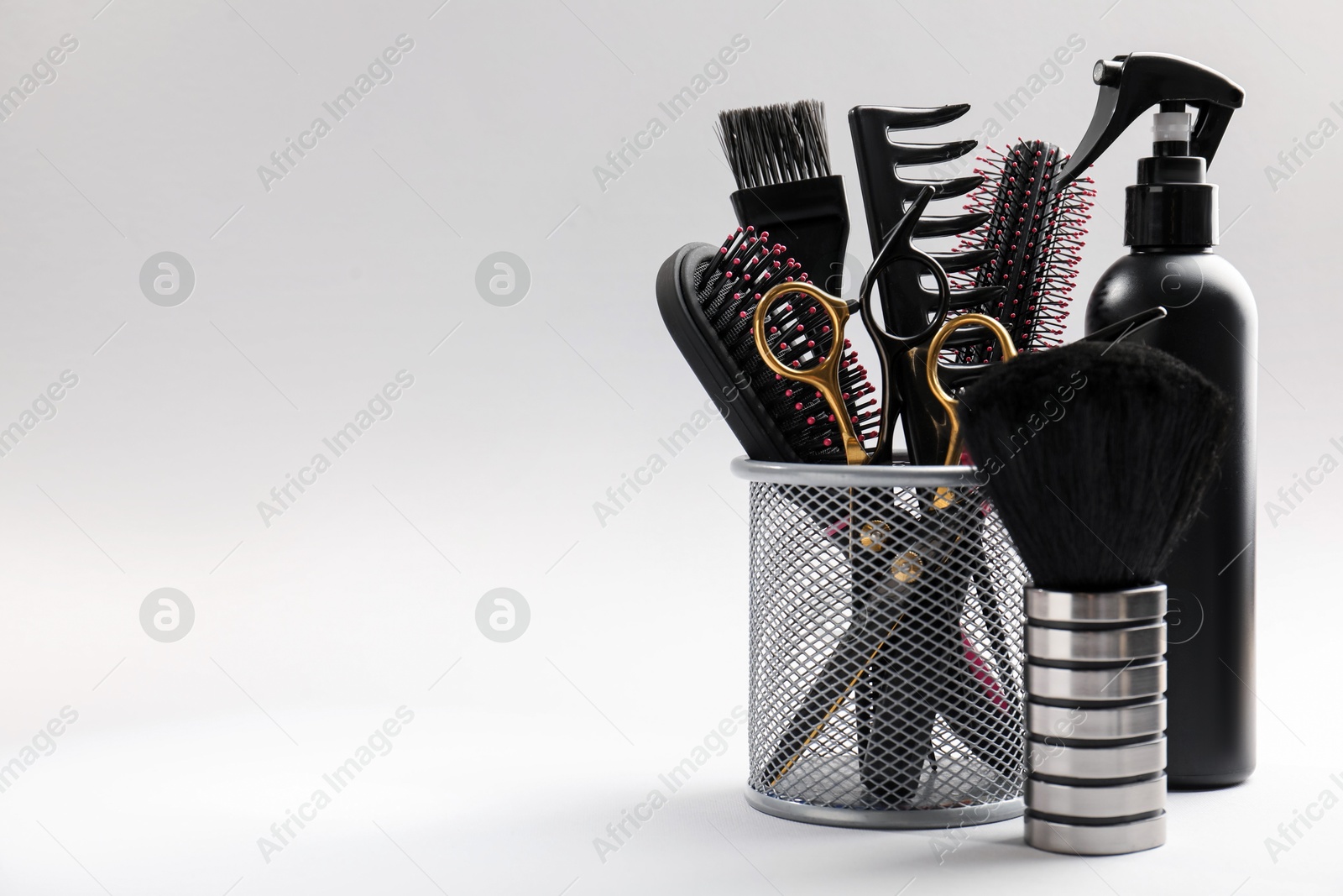 Different hairdresser's tools on light grey background, closeup. Space for text Photo of Different hairdresser's tools on light grey background, closeup. Space for text