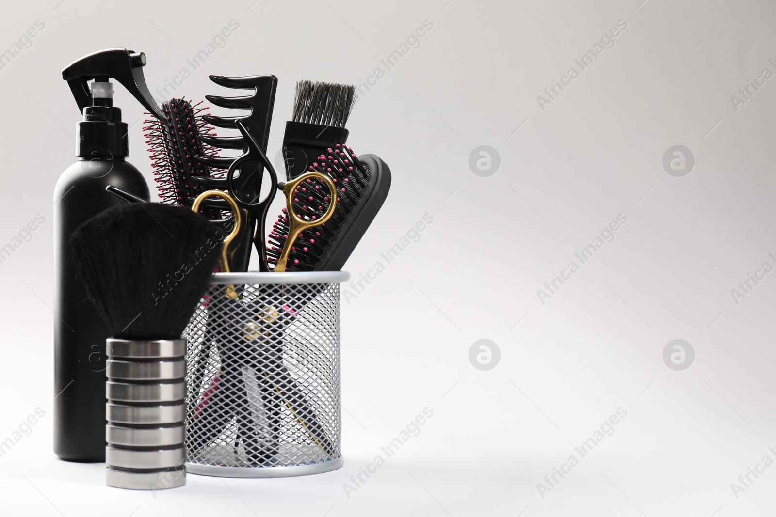 Different hairdresser's tools on light grey background, closeup. Space for text Photo of Different hairdresser's tools on light grey background, closeup. Space for text