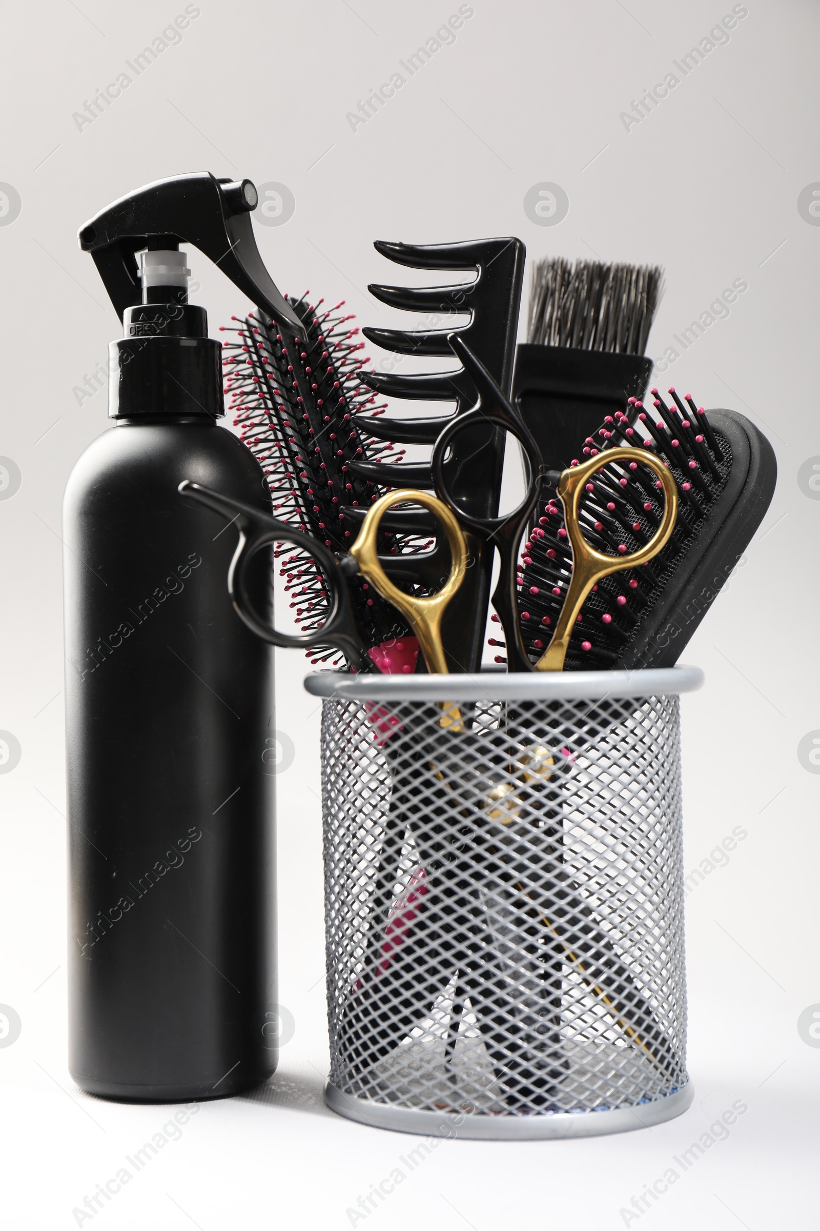 Different hairdresser's tools on light grey background, closeup Photo of Different hairdresser's tools on light grey background, closeup