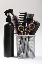 Photo of Different hairdresser's tools on light grey background, closeup
