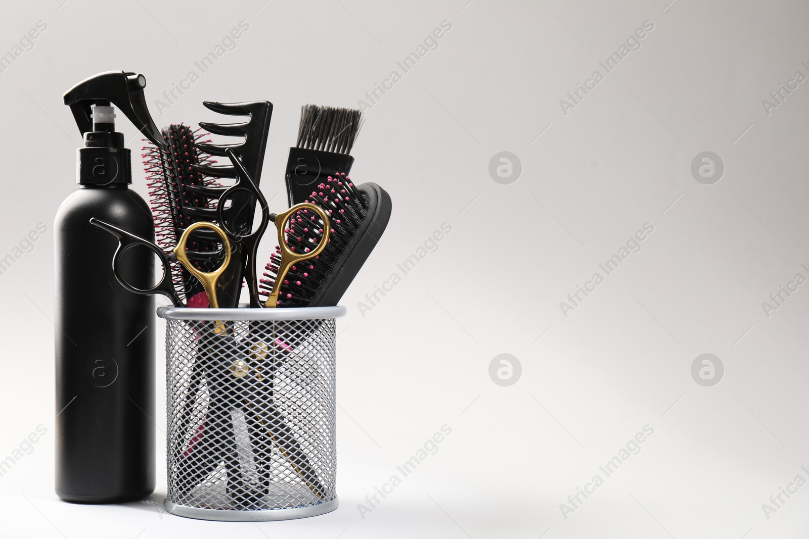 Different hairdresser's tools on light grey background, closeup. Space for text Photo of Different hairdresser's tools on light grey background, closeup. Space for text