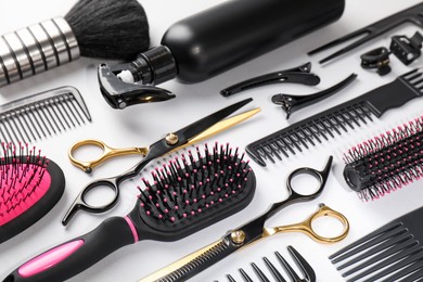 Photo of Different hairdresser's tools on light grey background