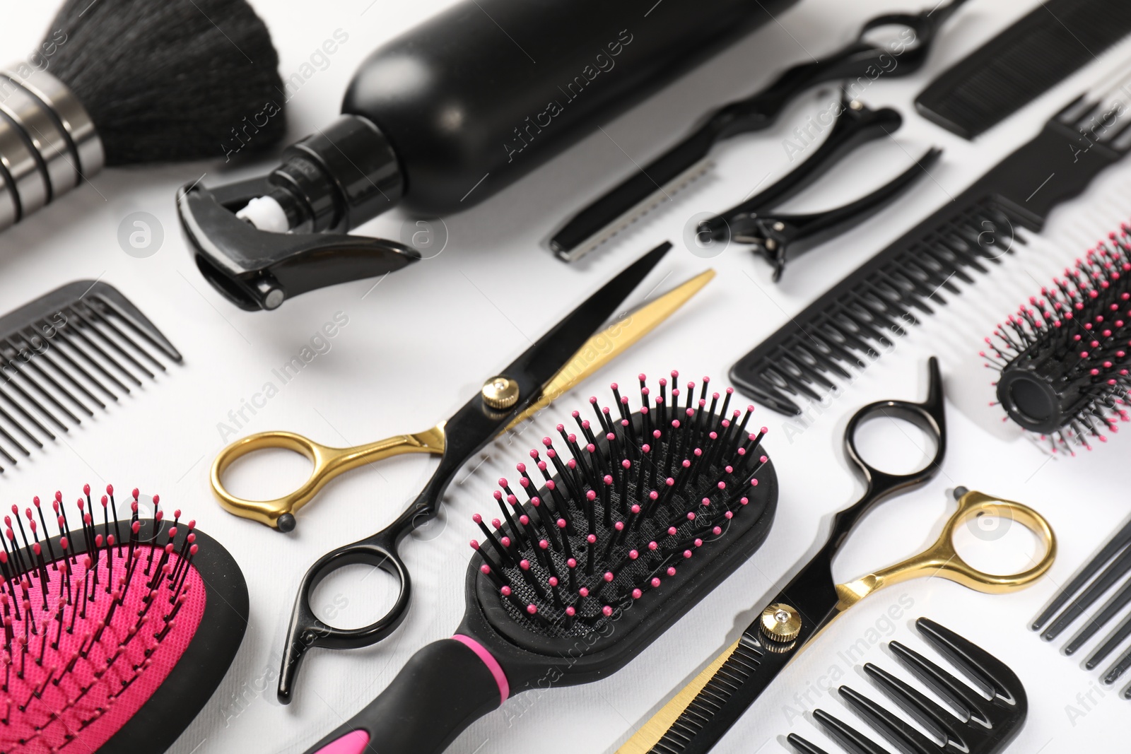Different hairdresser's tools on light grey background Photo of Different hairdresser's tools on light grey background