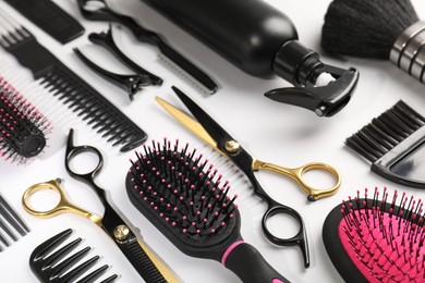 Photo of Different hairdresser's tools on light grey background