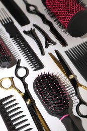 Photo of Different hairdresser's tools on light grey background, above view