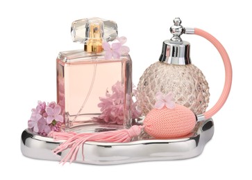 Photo of Luxury perfumes and beautiful lilac flowers isolated on white