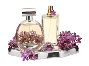 Photo of Luxury perfumes and beautiful lilac flowers isolated on white