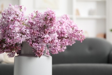 Photo of Beautiful lilac flowers in vase indoors, closeup