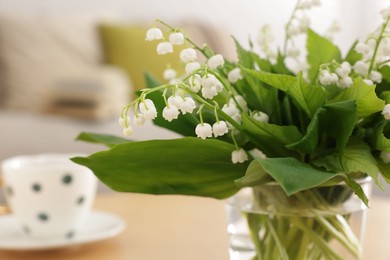 Photo of Bouquet of beautiful lily-of-the-valley at home, closeup