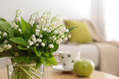 Photo of Bouquet of beautiful lily-of-the-valley at home, closeup. Space for text