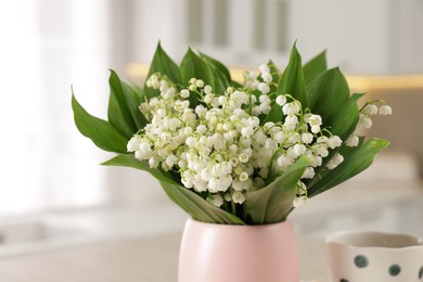 Photo of Bouquet of beautiful lily-of-the-valley at home, closeup