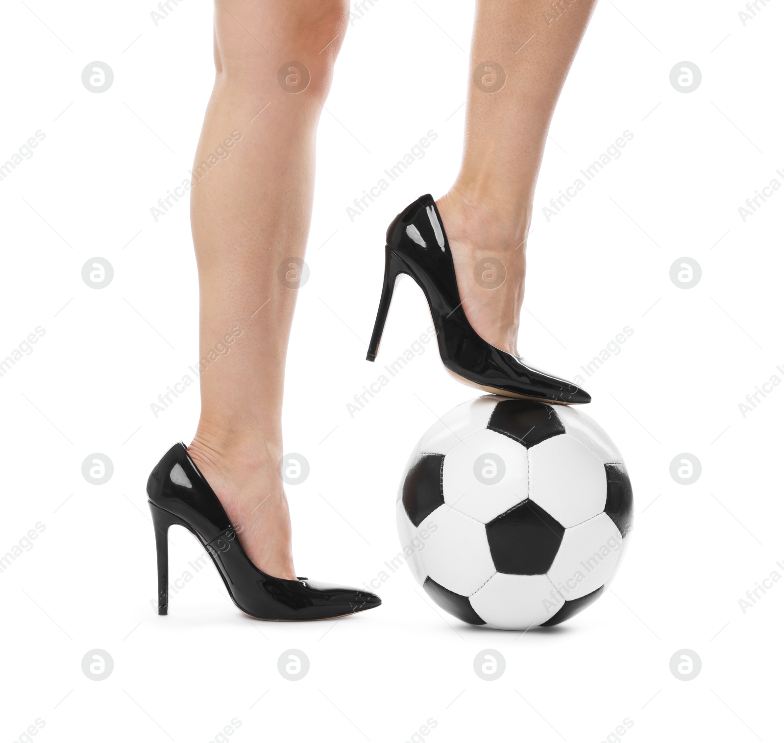 Photo of Woman in high heeled shoes with soccer ball on white background, closeup
