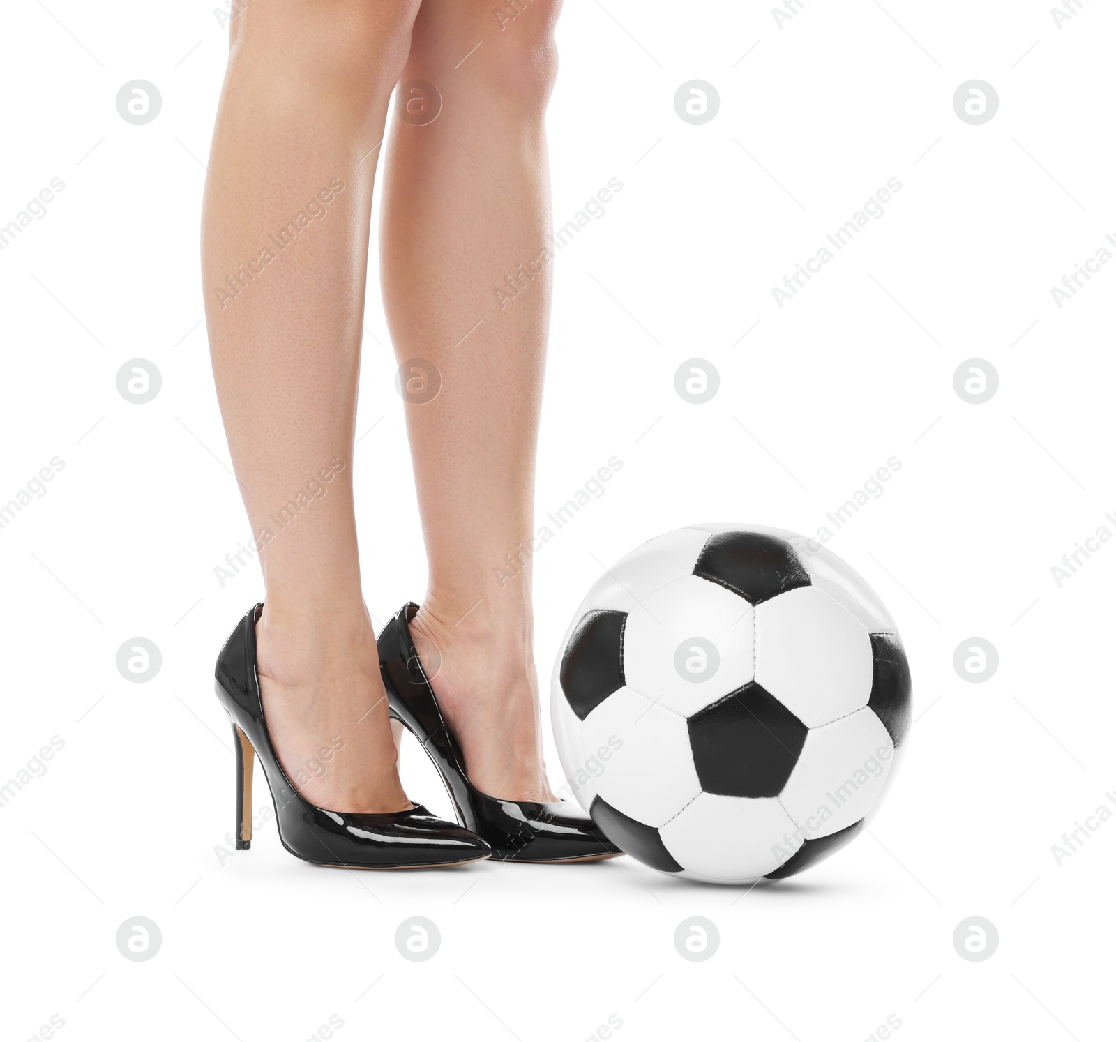 Photo of Woman in high heeled shoes with soccer ball on white background, closeup