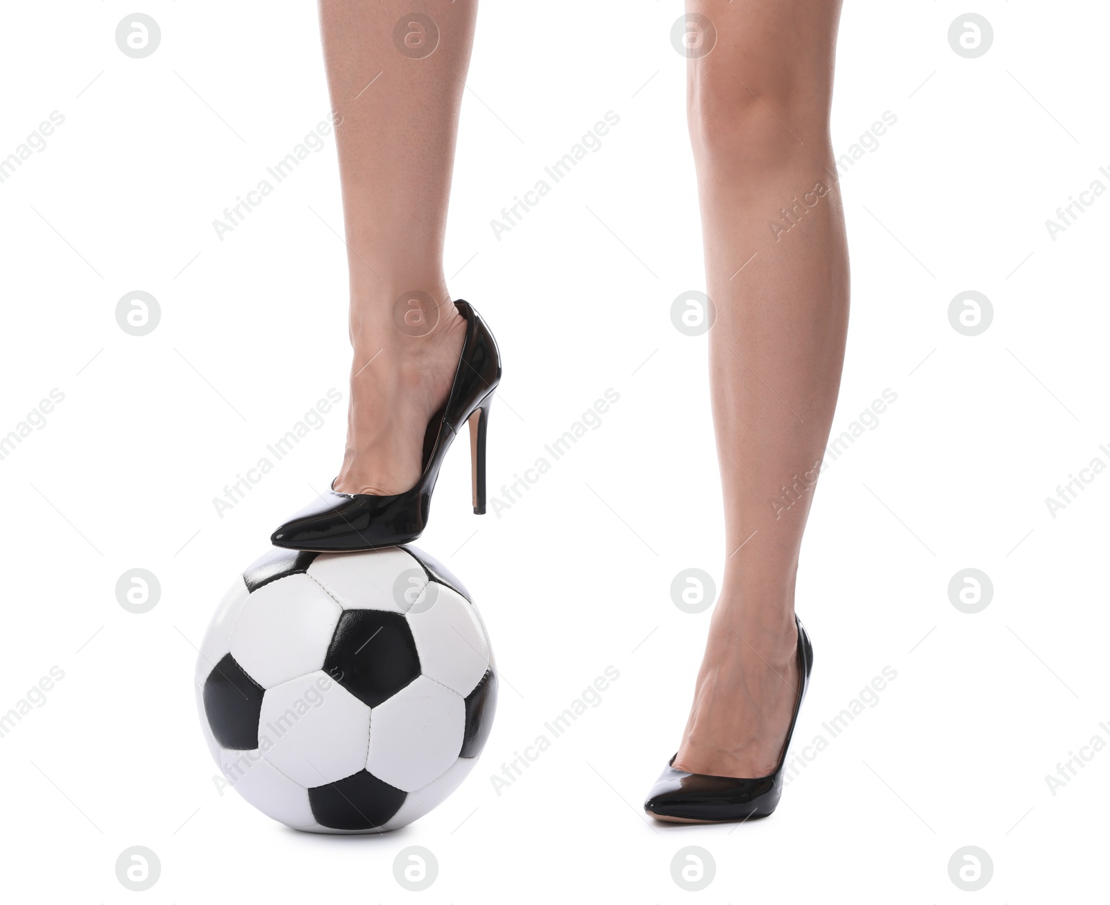 Photo of Woman in high heeled shoes with soccer ball on white background, closeup