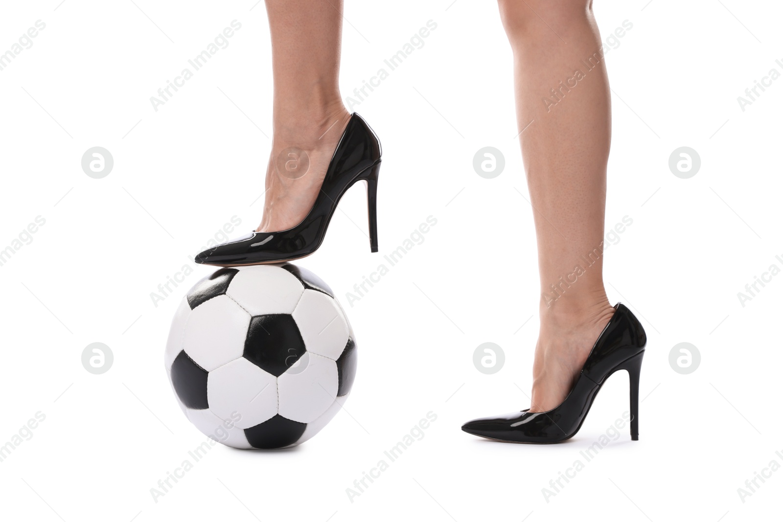 Photo of Woman in high heeled shoes with soccer ball on white background, closeup
