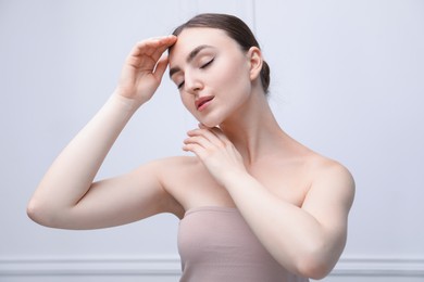 Photo of Woman with beautiful collarbones on light background