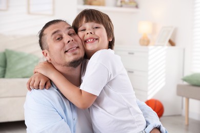 Photo of Portrait of father and his son at home