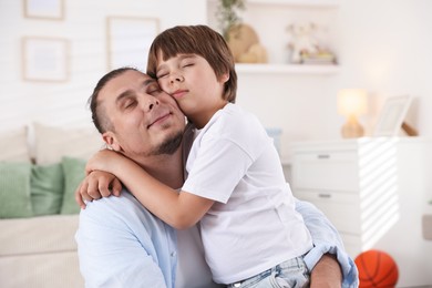 Photo of Portrait of father and his son at home