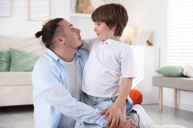 Photo of Portrait of father and his son at home