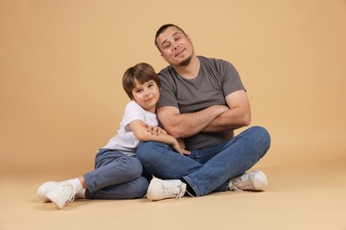 Photo of Father and his son on beige background