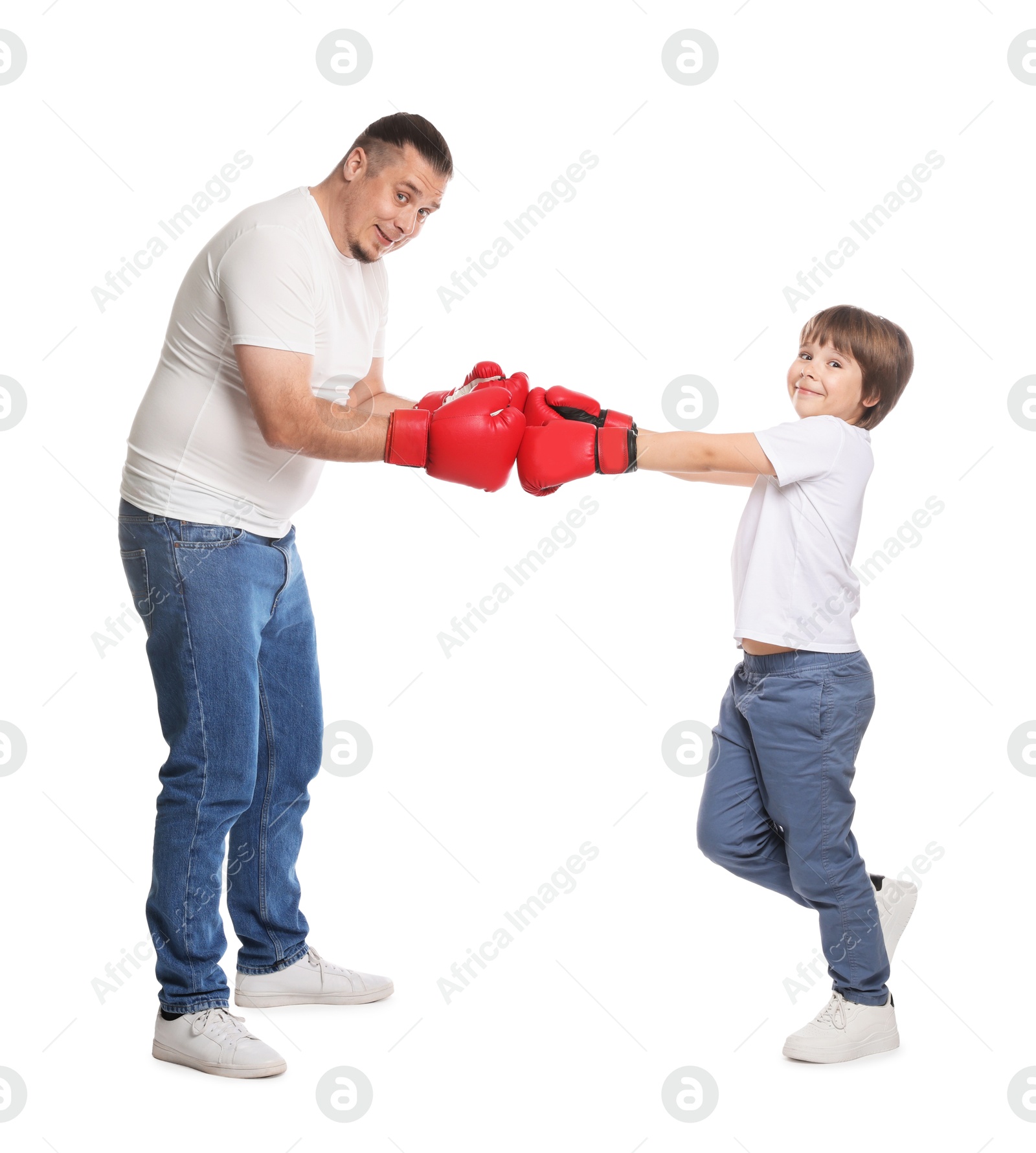 Father and his son boxing on white background Photo of Father and his son boxing on white background