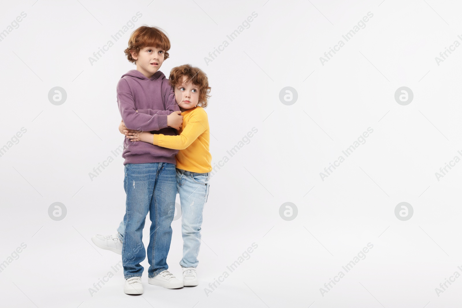 Cute little brothers hugging on white background Photo of Cute little brothers hugging on white background
