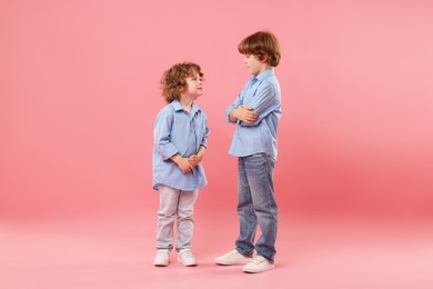 Photo of Cute little brothers together on pink background