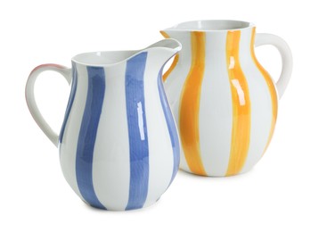 Photo of Two striped ceramic jugs isolated on white