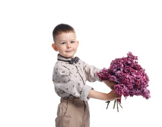 Photo of Little boy with bouquet of lilac flowers on white background