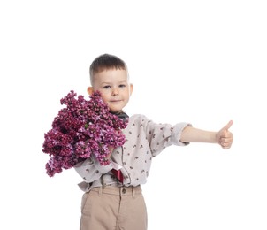 Photo of Little boy with bouquet of lilac flowers showing thumbs up on white background