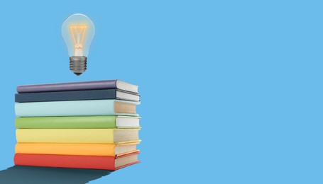 Image of Idea and knowledge. Light bulb in air over stack of books on light blue background, space for text. Banner design