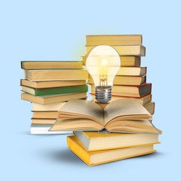 Image of Light bulb in air over books on pastel blue background. Idea and knowledge
