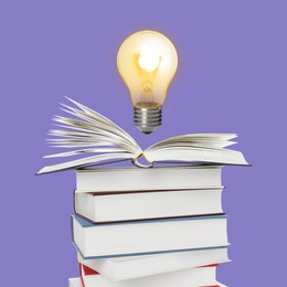 Image of Light bulb in air over stack of books on violet background. Idea and knowledge