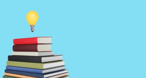 Image of Idea and knowledge. Light bulb in air over stack of books on light blue background, space for text. Banner design