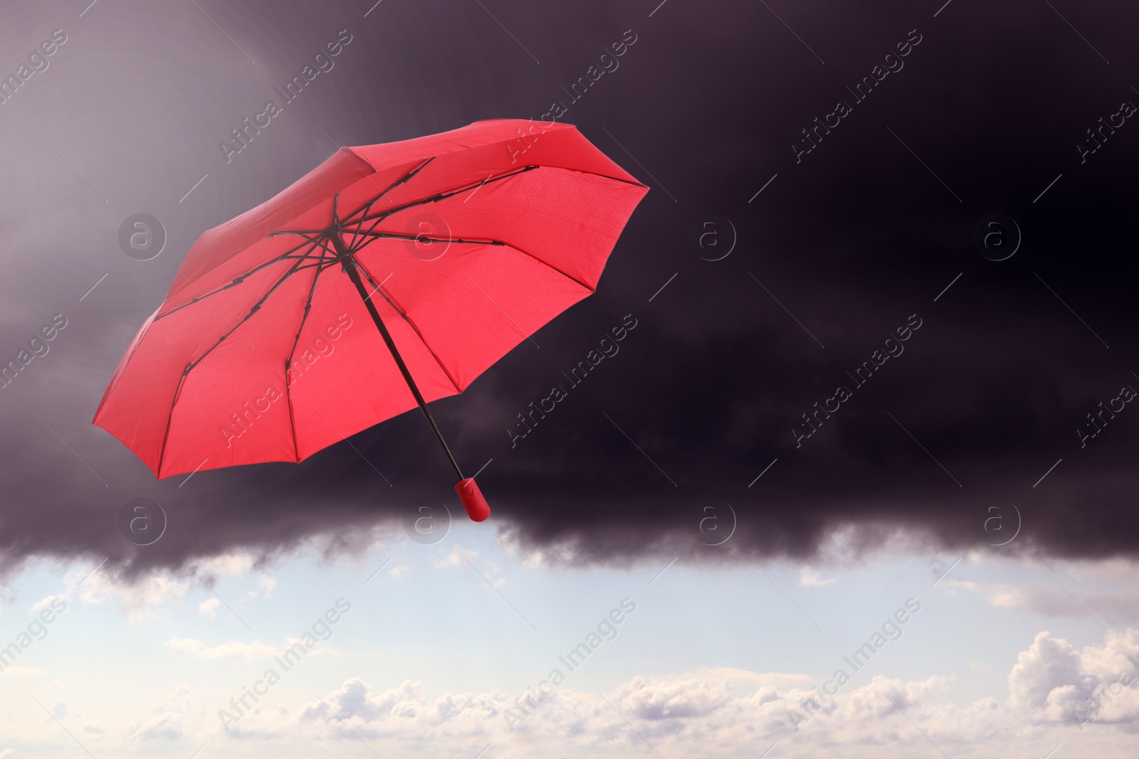 Red umbrella flying in cloudy sky. Stormy weather Image of Red umbrella flying in cloudy sky. Stormy weather
