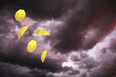 Image of Yellow umbrellas flying in dark cloudy sky under heavy rain. Stormy weather