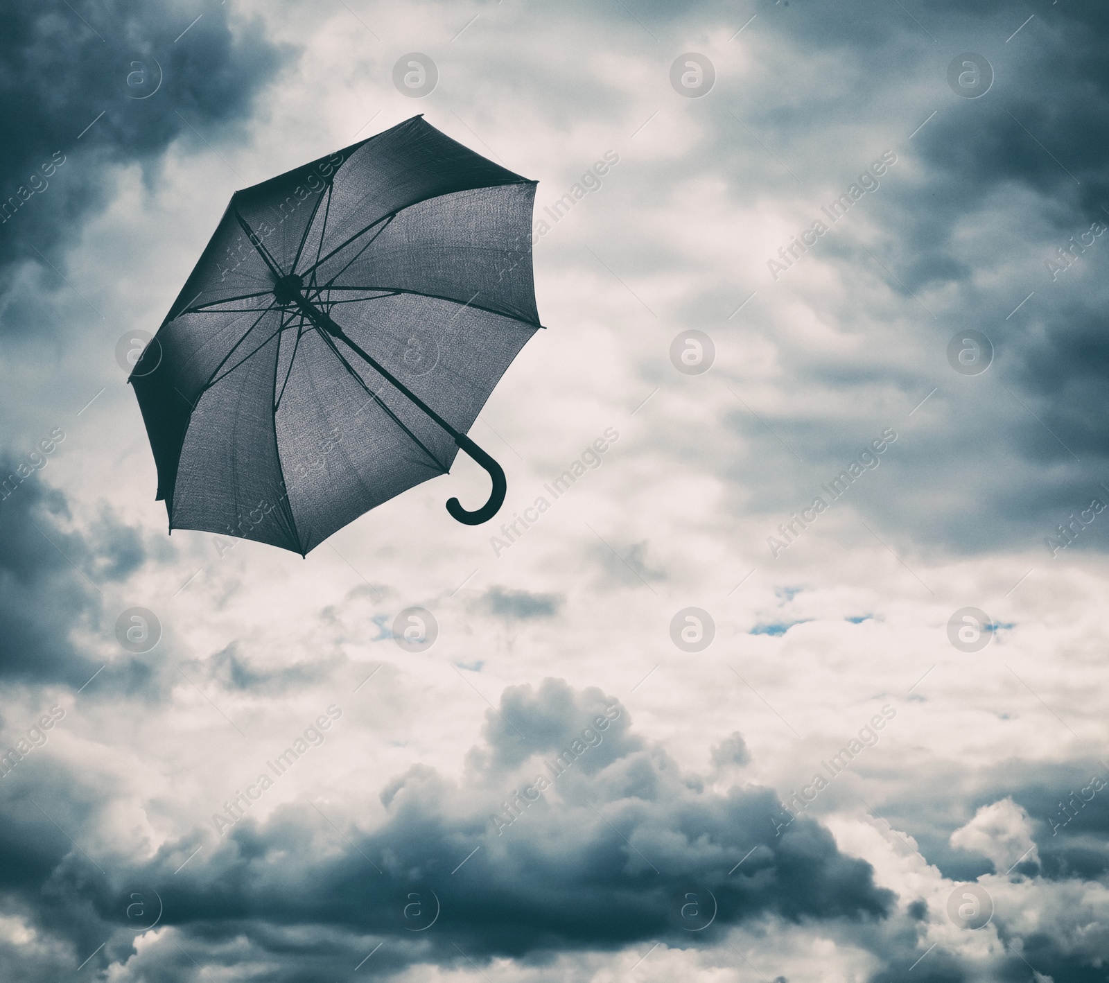 Black umbrella flying in cloudy sky. Stormy weather Image of Black umbrella flying in cloudy sky. Stormy weather