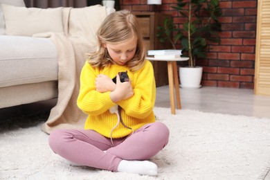 Photo of Little girl with cute rats on floor at home, space for text