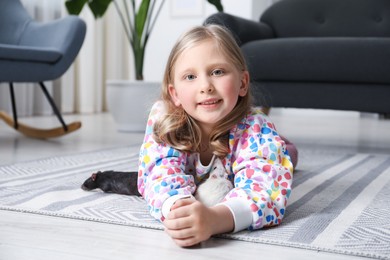 Photo of Little girl with cute rats on floor at home