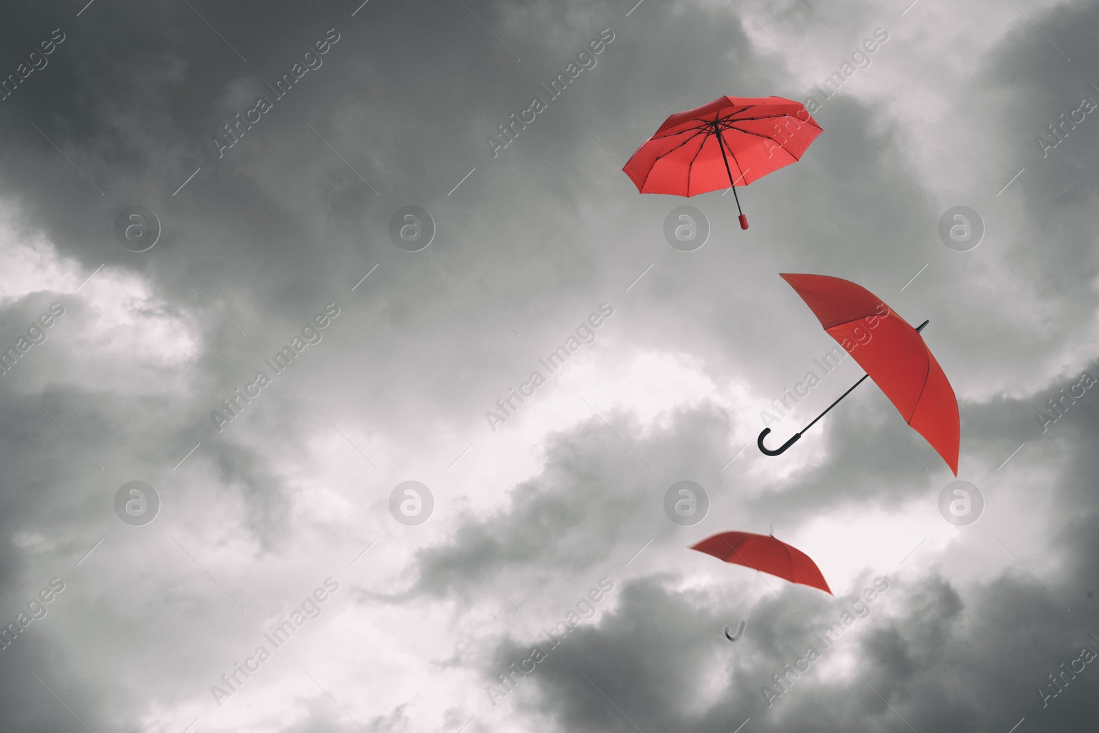 Red umbrellas flying in cloudy sky. Stormy weather Image of Red umbrellas flying in cloudy sky. Stormy weather