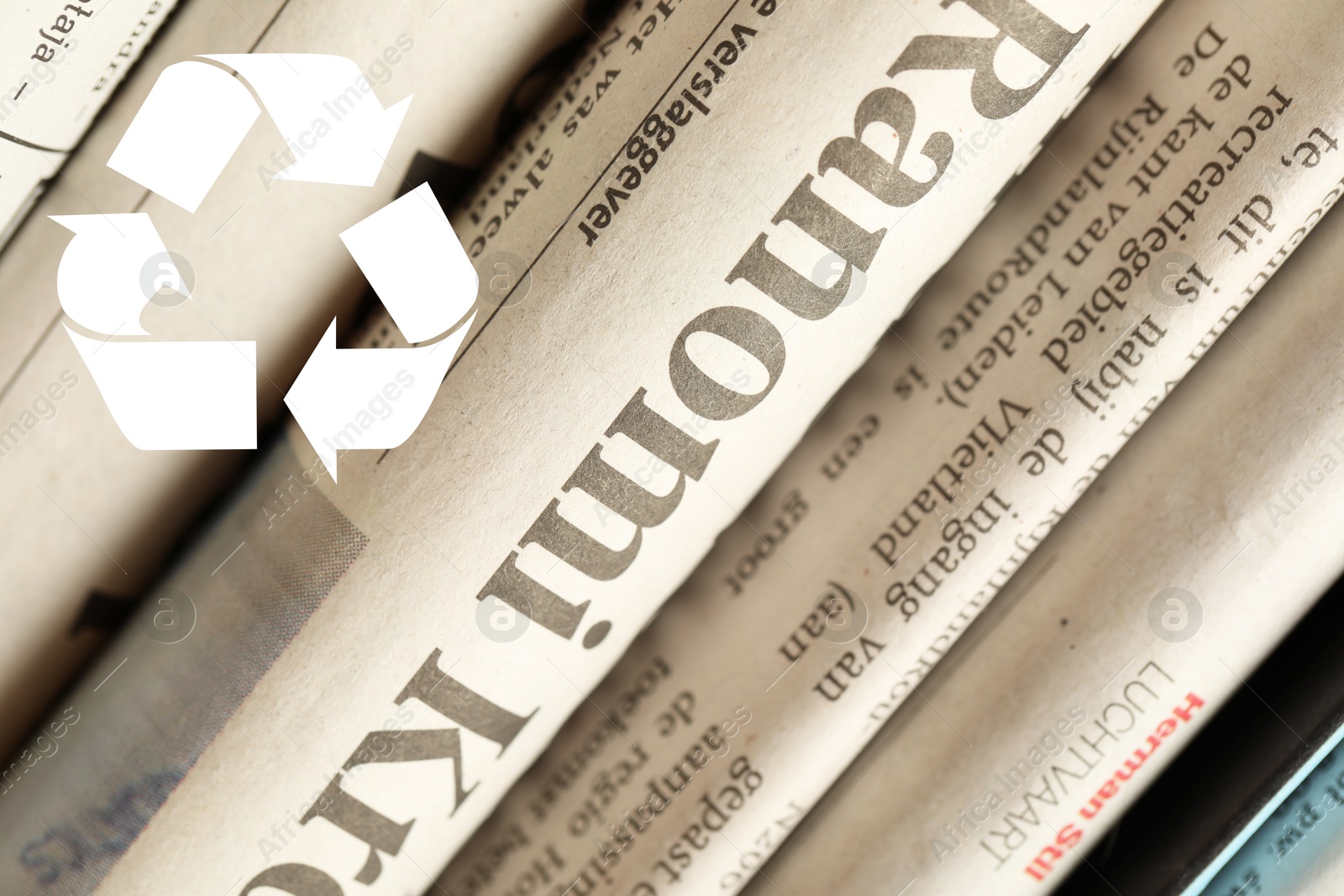 Recycling symbol and many newspapers in different languages as background, closeup. Eco-friendly lifestyle, reusing Image of Recycling symbol and many newspapers in different languages as background, closeup. Eco-friendly lifestyle, reusing