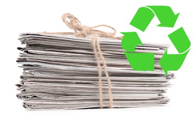 Image of Recycling symbol and stack of tied newspapers on white background. Eco-friendly lifestyle, reusing