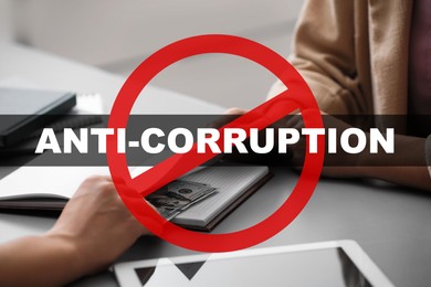 Image of Anti-corruption. Man offering bribe money at table indoors, closeup. Red stop sign